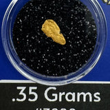 Gold nugget in a container with black sand, labeled '.35 Grams #3200' and 'BobbyNugget.com'.