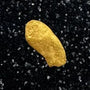 Gold nugget in a clear container with black sand on a blue background, labeled '.20 Grams #3202' and 'BobbyNugget.com'.