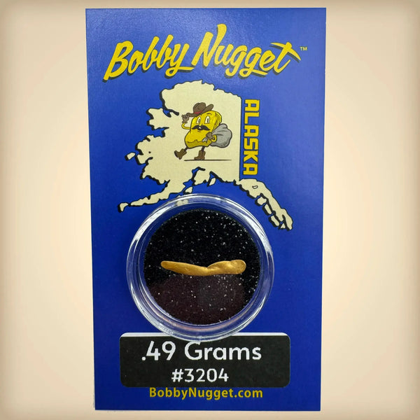 Bobby Nugget Alaska gold nugget packaging with blue background and gold nugget in clear container.