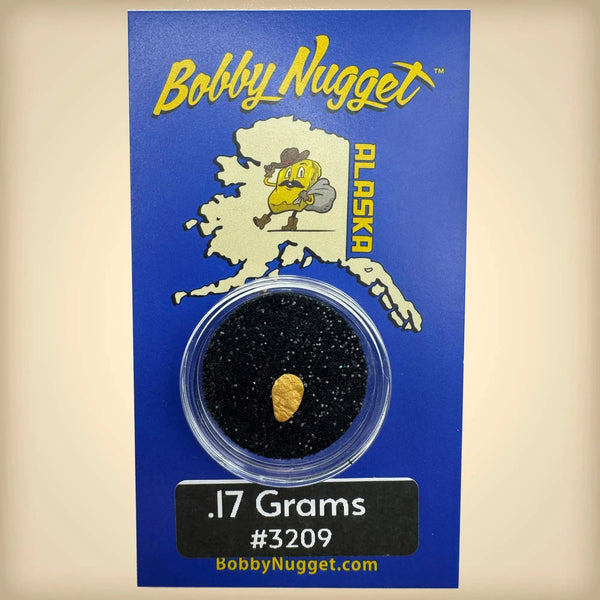 Gold nugget in a clear container on a blue card with 'Bobby Nugget' branding.