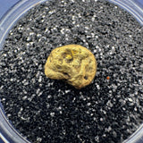 Close-up view highlighting the raw texture and natural edges of a genuine gold nugget  