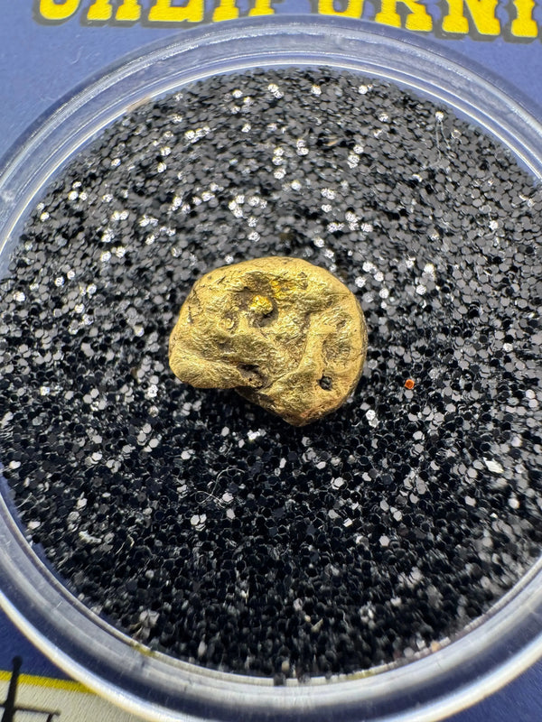 Close-up view highlighting the raw texture and natural edges of a genuine gold nugget  