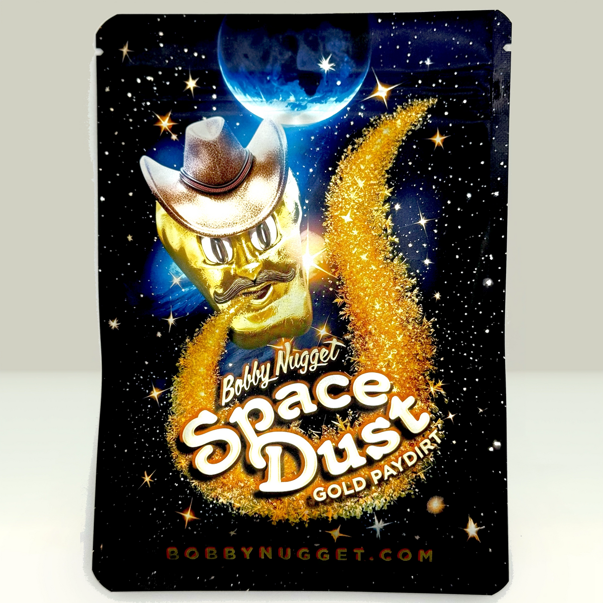 Product packaging with a gold cowboy figure, space-themed design, and 'Bobby Nugget Space Dust' text.